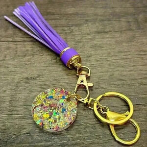 Gold Tone Keychain with Hand Crafted Sparkles Amulet and Purple Tassel